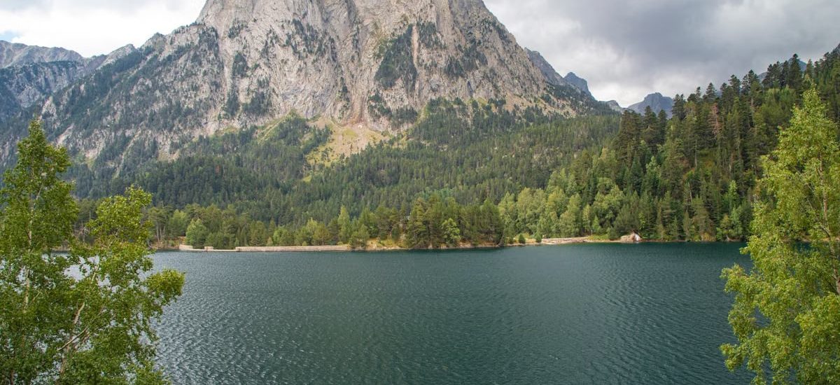 Beautiful landscape of Estany de Sant Maurici with Gran Encantat in the background, Catalonia, Spain.